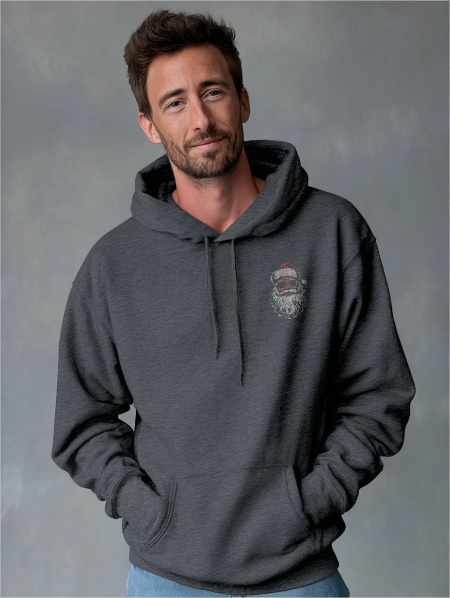 Dark Heather Heather navy men’s hoodie with small vintage Santa face and sunglasses chest print, modeled by a man standing in a studio with a gray background, hands in the front pocket.