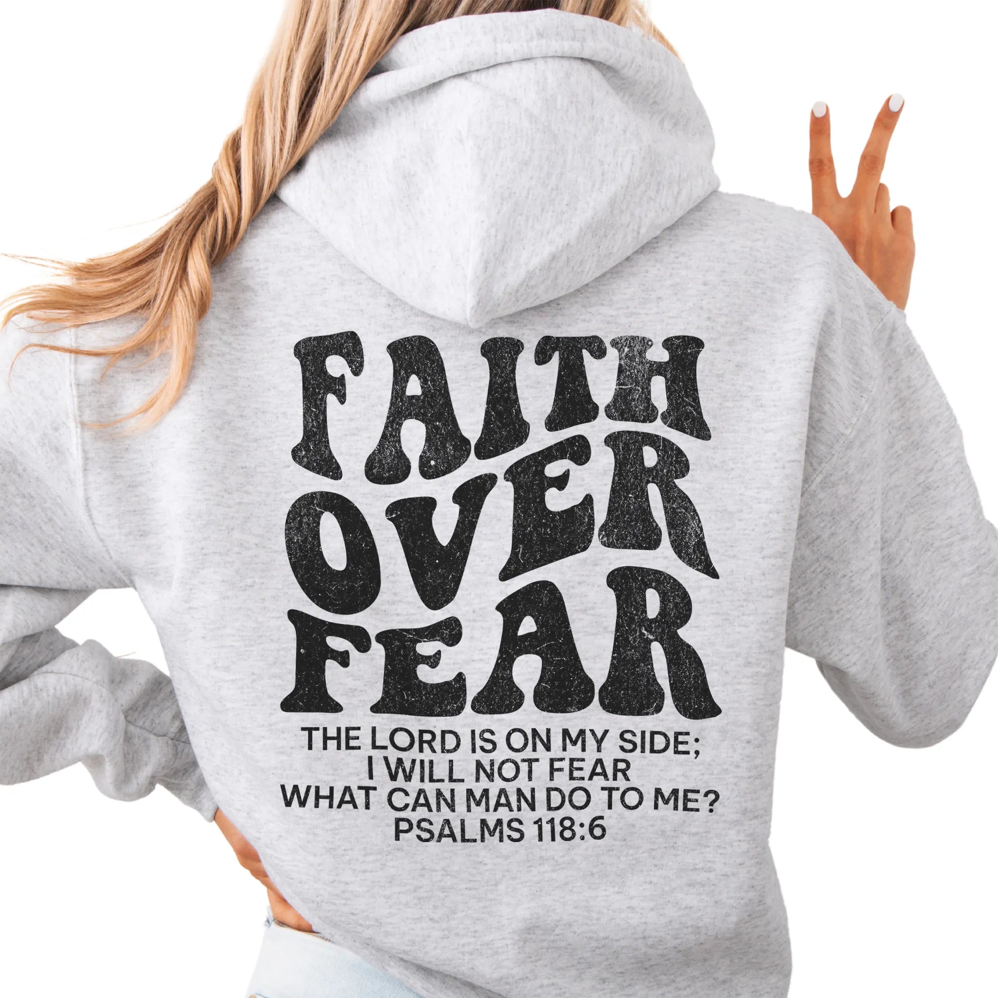 Ash Oakley June hoodie, large back lettering reads Faith Over Fear with supporting scripture lines, hood up, studio back view