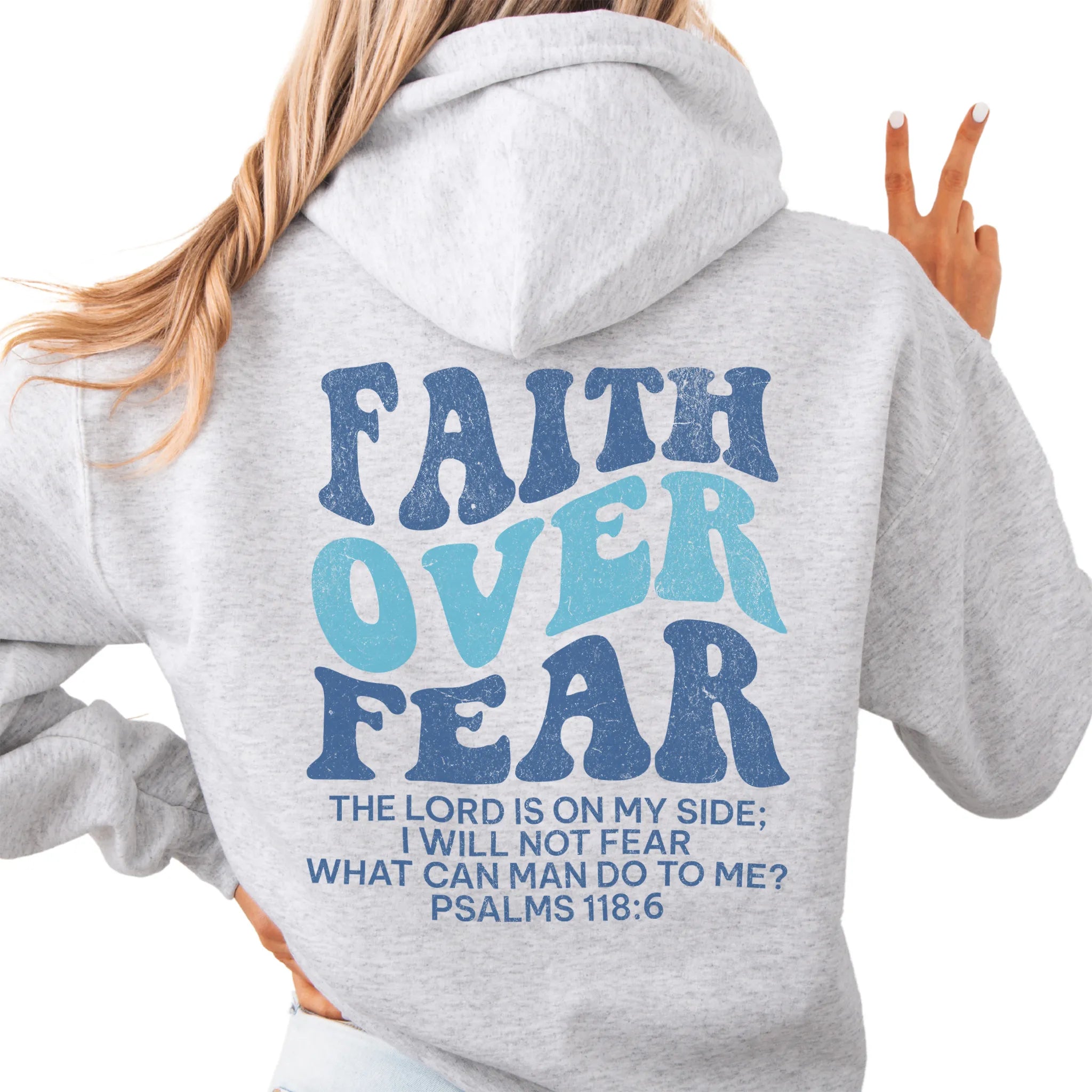 Ash Oakley June hoodie, large back lettering reads Faith Over Fear with supporting scripture lines, hood up, studio back view