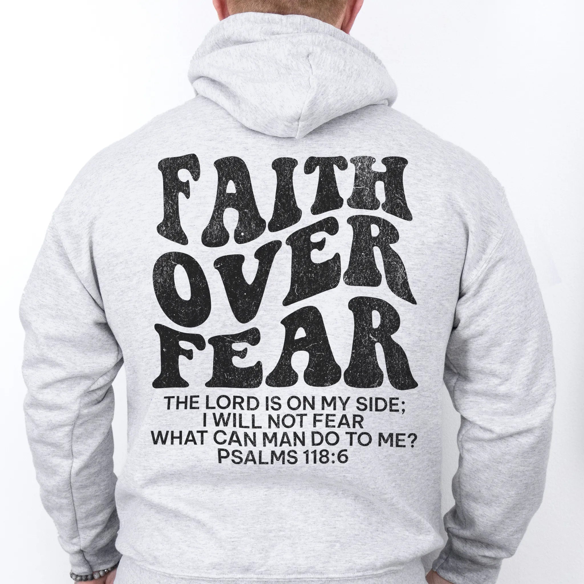 Ash Oakley June hoodie, mens fit, large back lettering reads Faith Over Fear with supporting scripture lines, studio back view