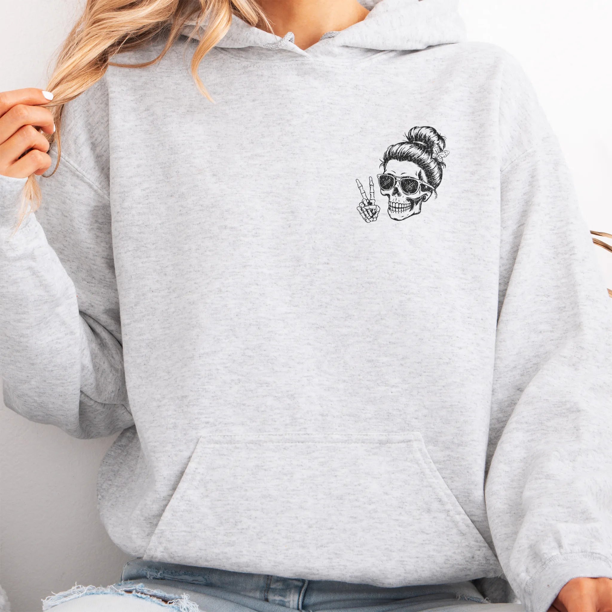 Ash Oakley June Hoodie front view small left chest skull with messy bun peace sign minimalist mark kangaroo pocket drawstrings visible distressed print
