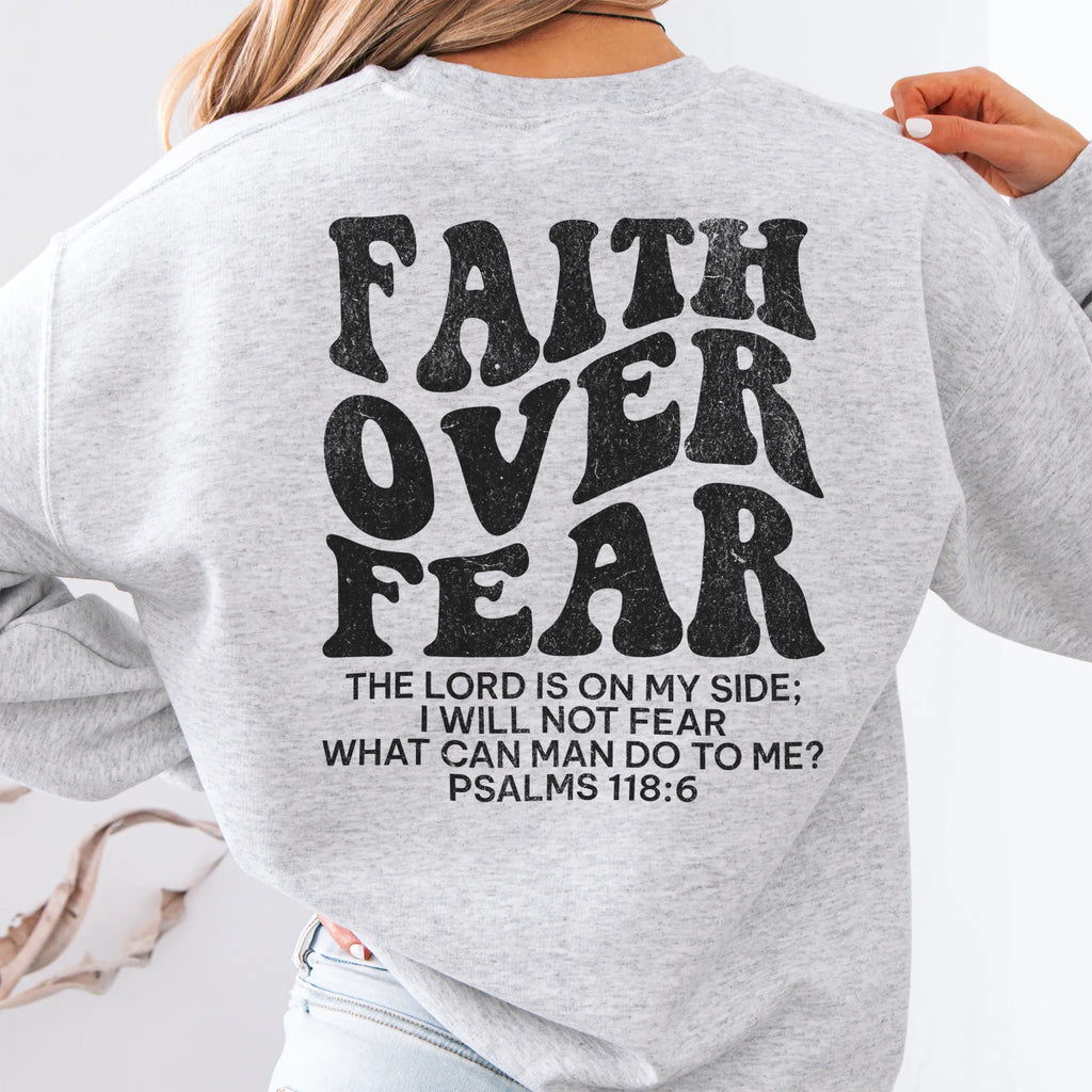 Ash Oakley June sweatshirt, large back lettering reads Faith Over Fear with supporting scripture lines, studio back view