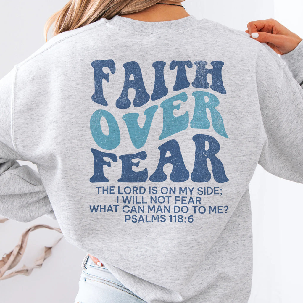 Ash Oakley June sweatshirt, large back lettering reads Faith Over Fear with supporting scripture lines, studio back view