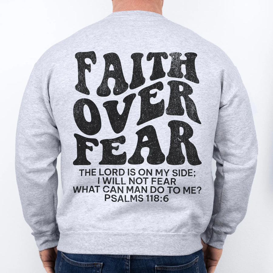 Ash Oakley June sweatshirt, mens fit, large back lettering reads Faith Over Fear with supporting scripture lines, studio back view