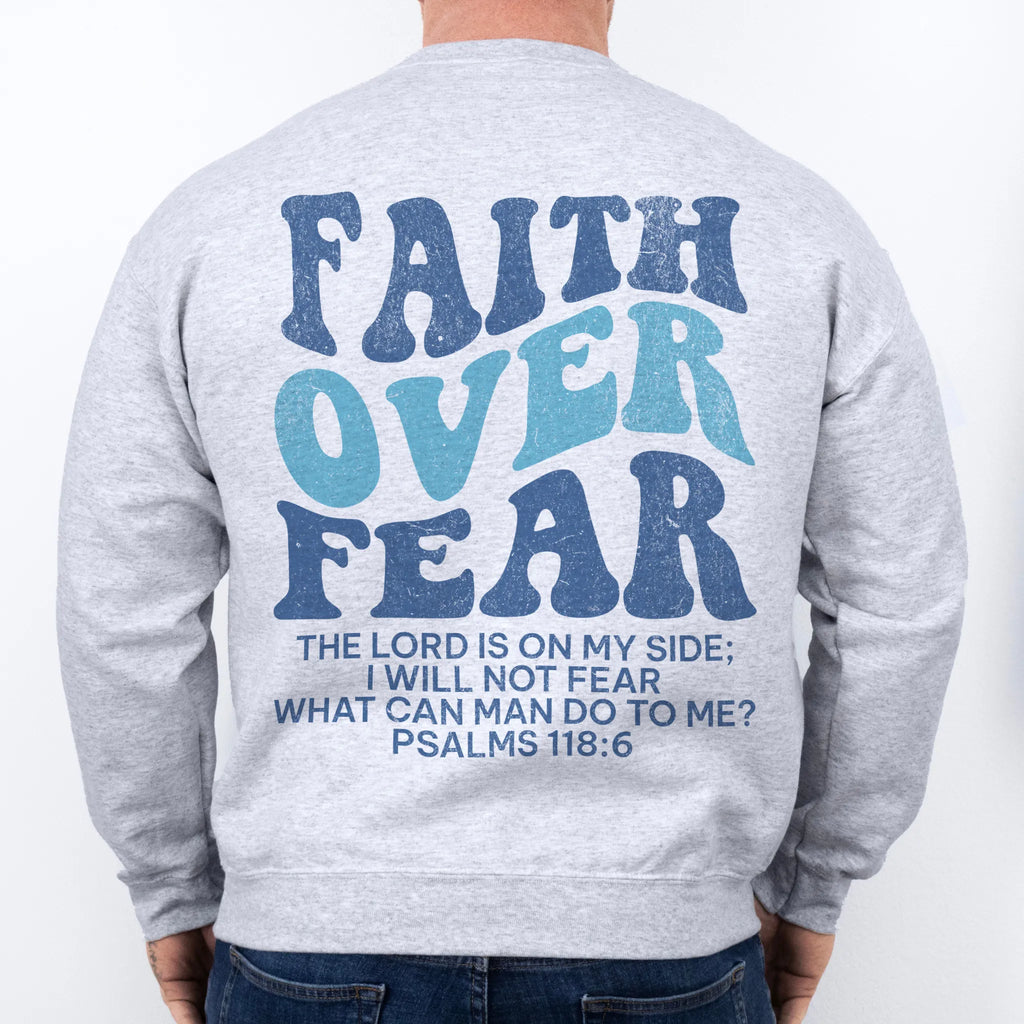 Ash Oakley June sweatshirt, mens fit, large back lettering reads Faith Over Fear with supporting scripture lines, studio back view