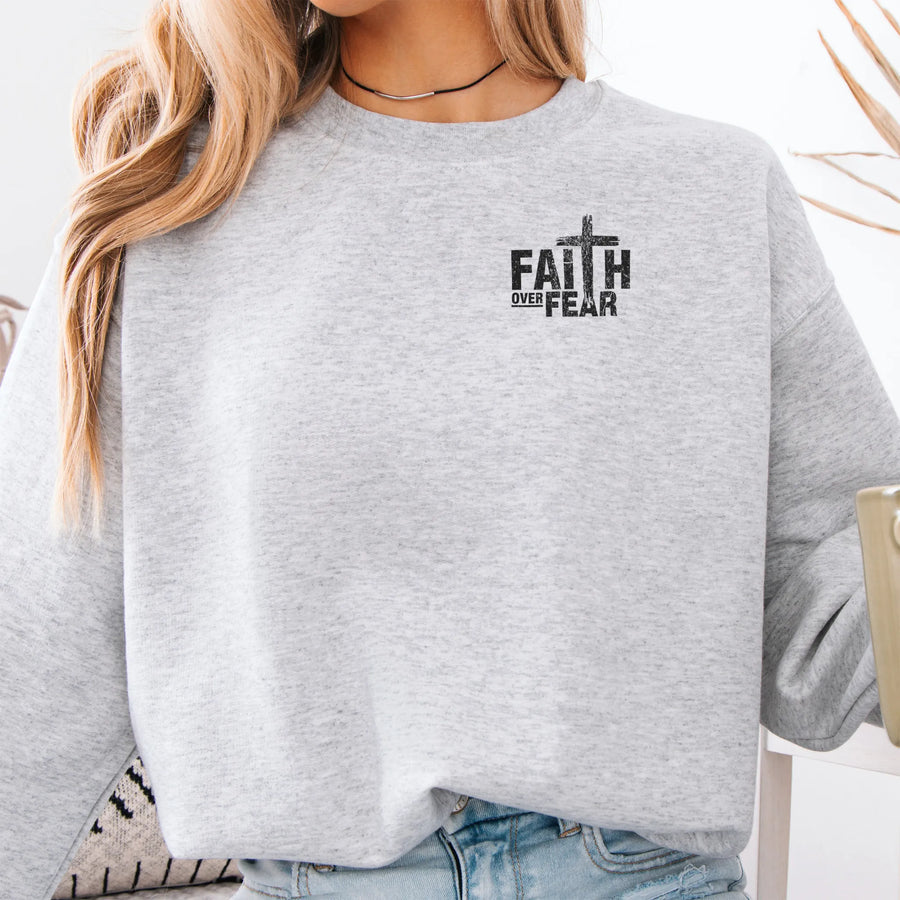 Ash Oakley June sweatshirt, left chest badge reads Faith Over Fear with small cross, relaxed modern fit, studio front view