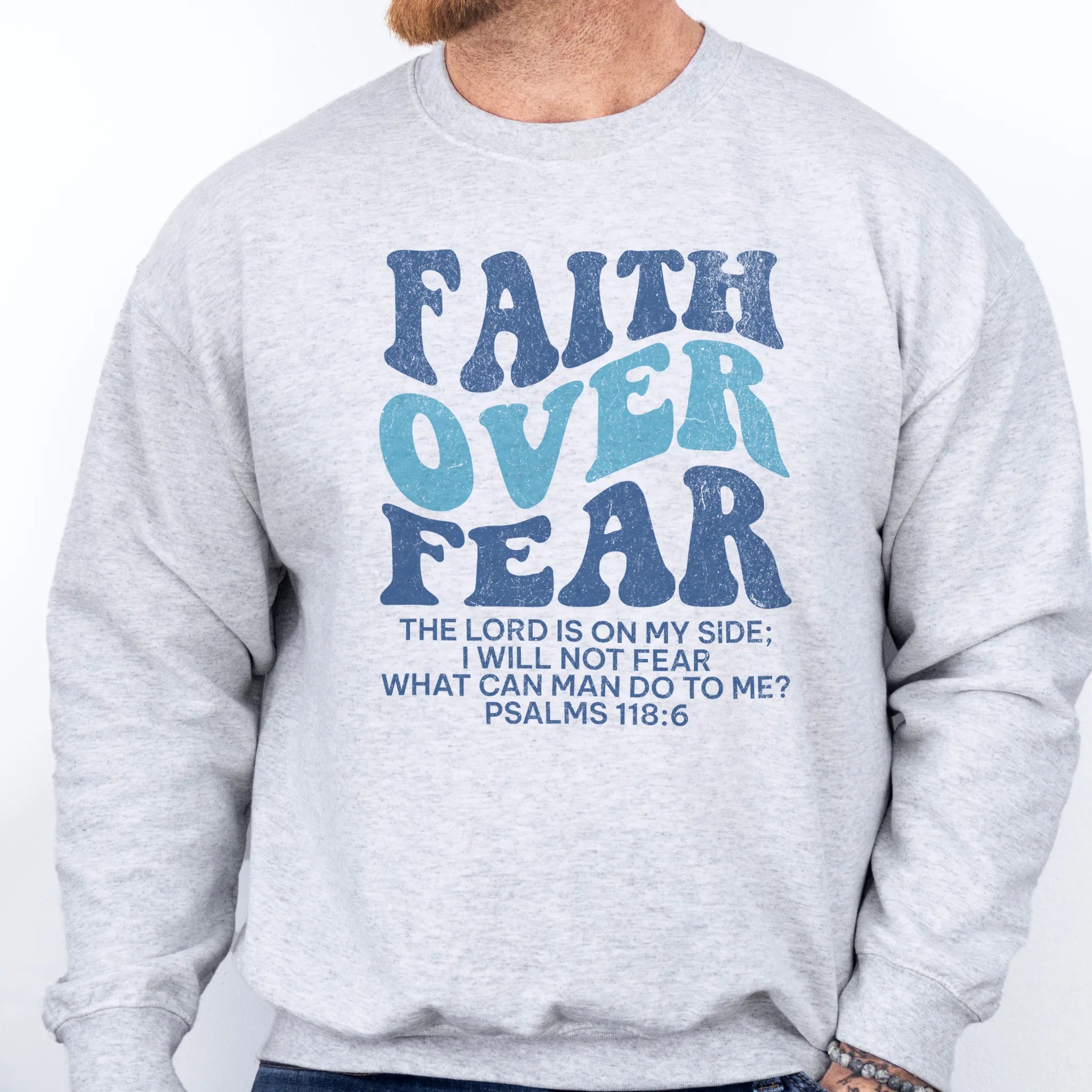 Ash Oakley June sweatshirt, mens fit, large front lettering reads Faith Over Fear with supporting lines The Lord Is On My Side I Will Not Fear What Can Man Do To Me, studio front view