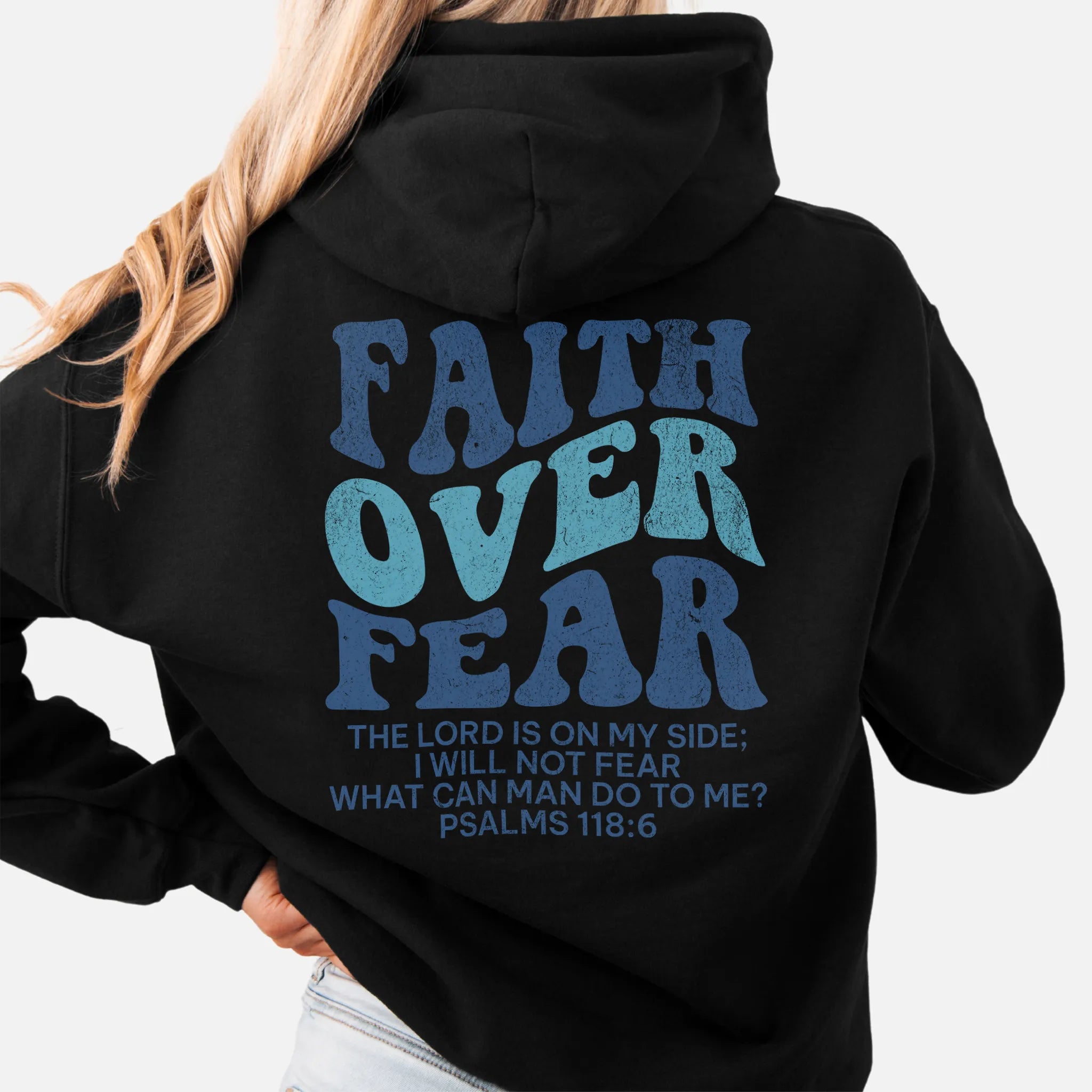Black Oakley June hoodie, large back lettering reads Faith Over Fear with supporting scripture lines, hood up, studio back view