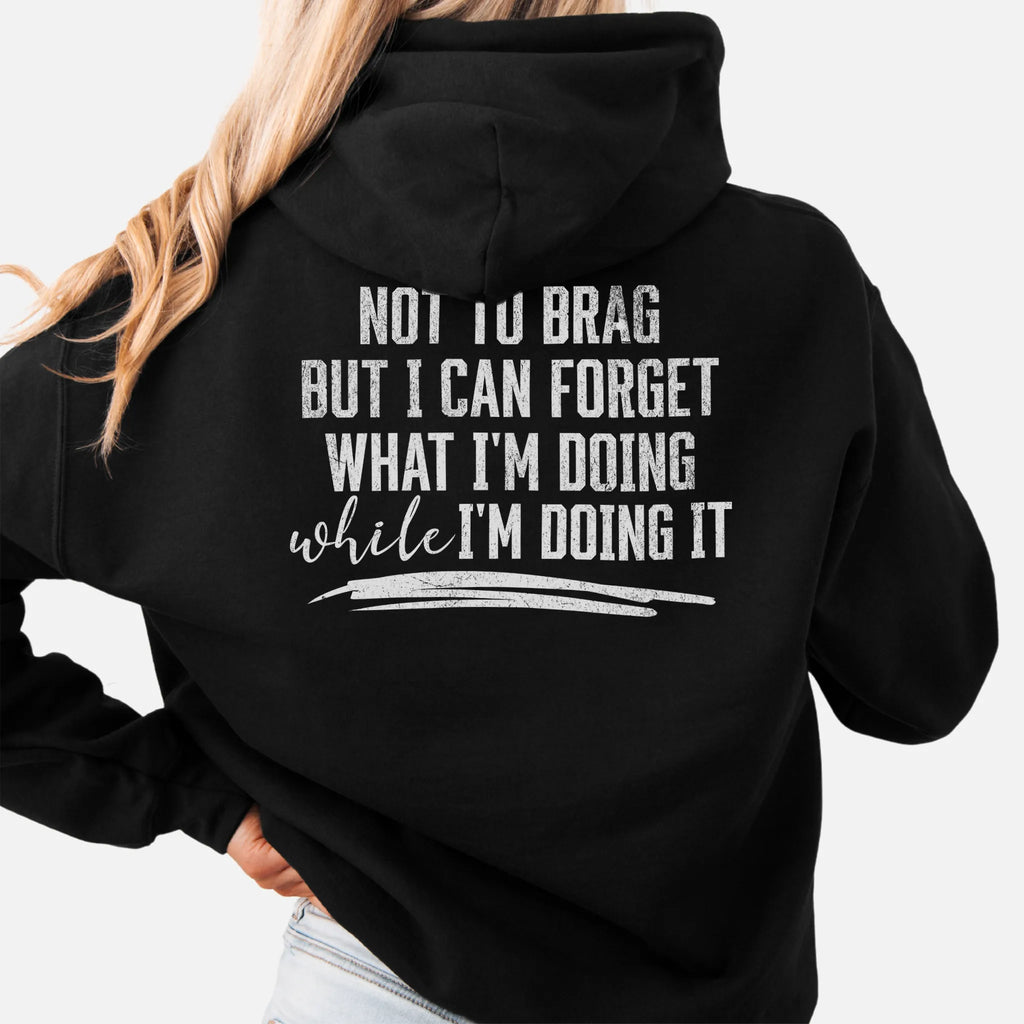 Black Oakley June Hoodie back view large text Not To Brag But I Can Forget What I’m Doing While I’m Doing It underline distressed print