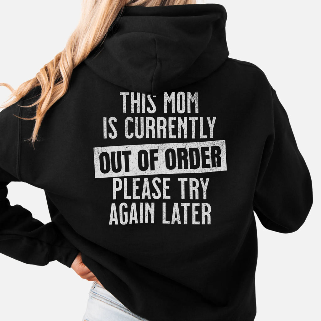Black hoodie – large back text reads “This Mom Is Currently Out of Order, Please Try Again Later”, relaxed modern fit with hood up, studio back view