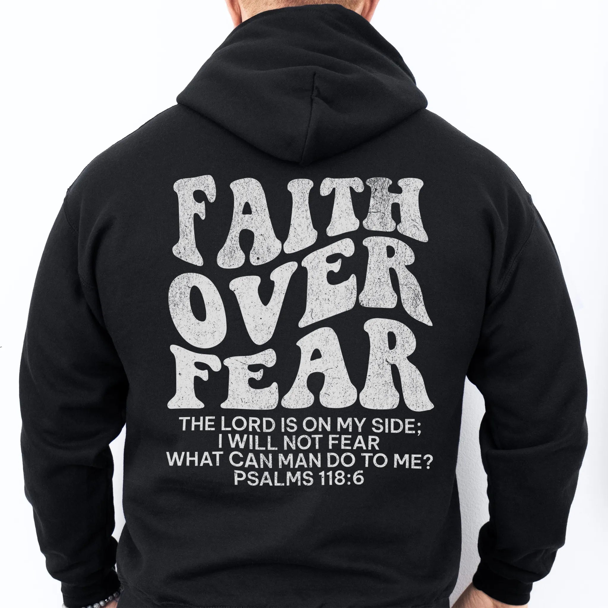 Black Oakley June hoodie, mens fit, large back lettering reads Faith Over Fear with supporting scripture lines, studio back view