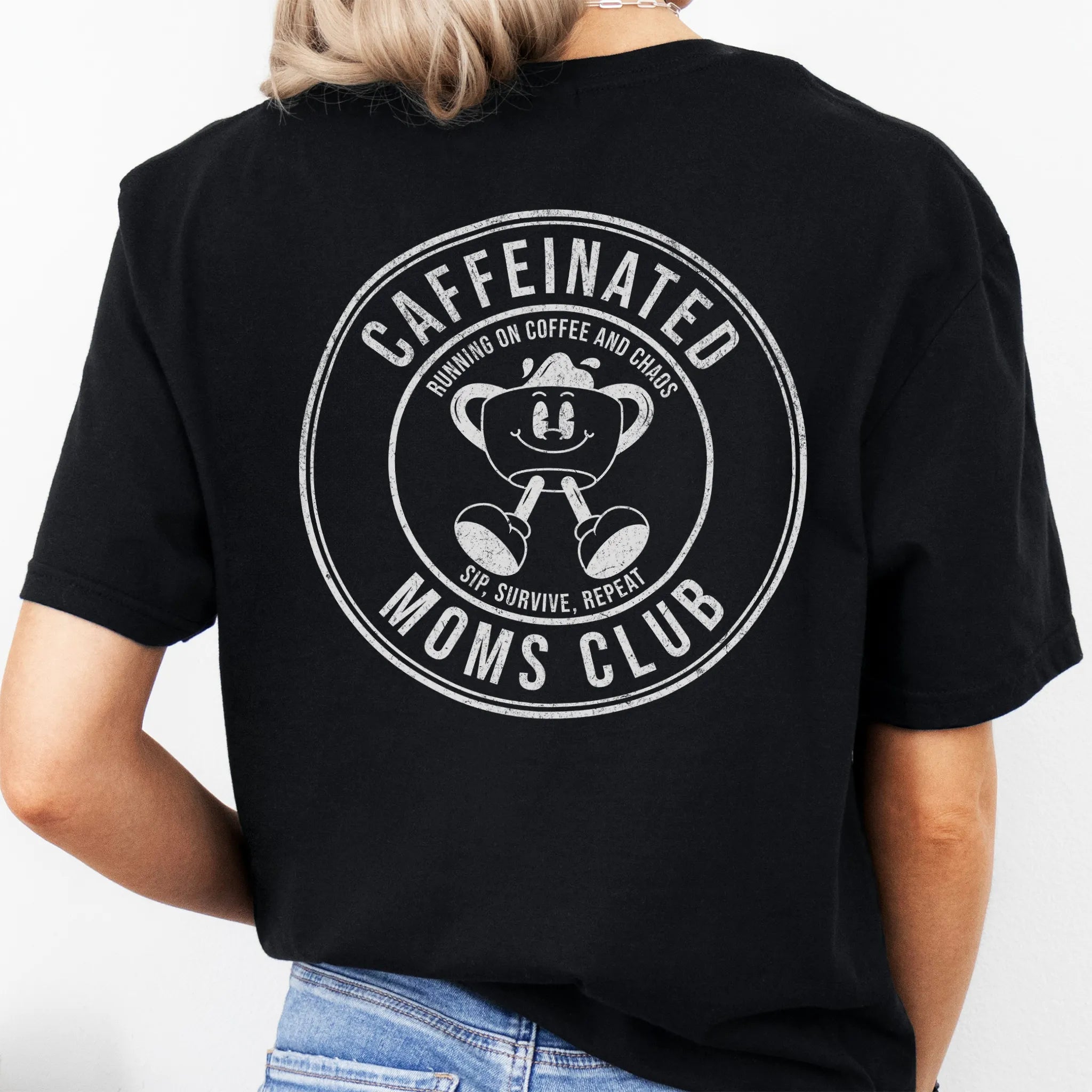 Black Oakley June T Shirt back view Caffeinated Moms Club large circle badge text Running on Coffee and Chaos Sip Survive Repeat vintage mascot coffee cup distressed print