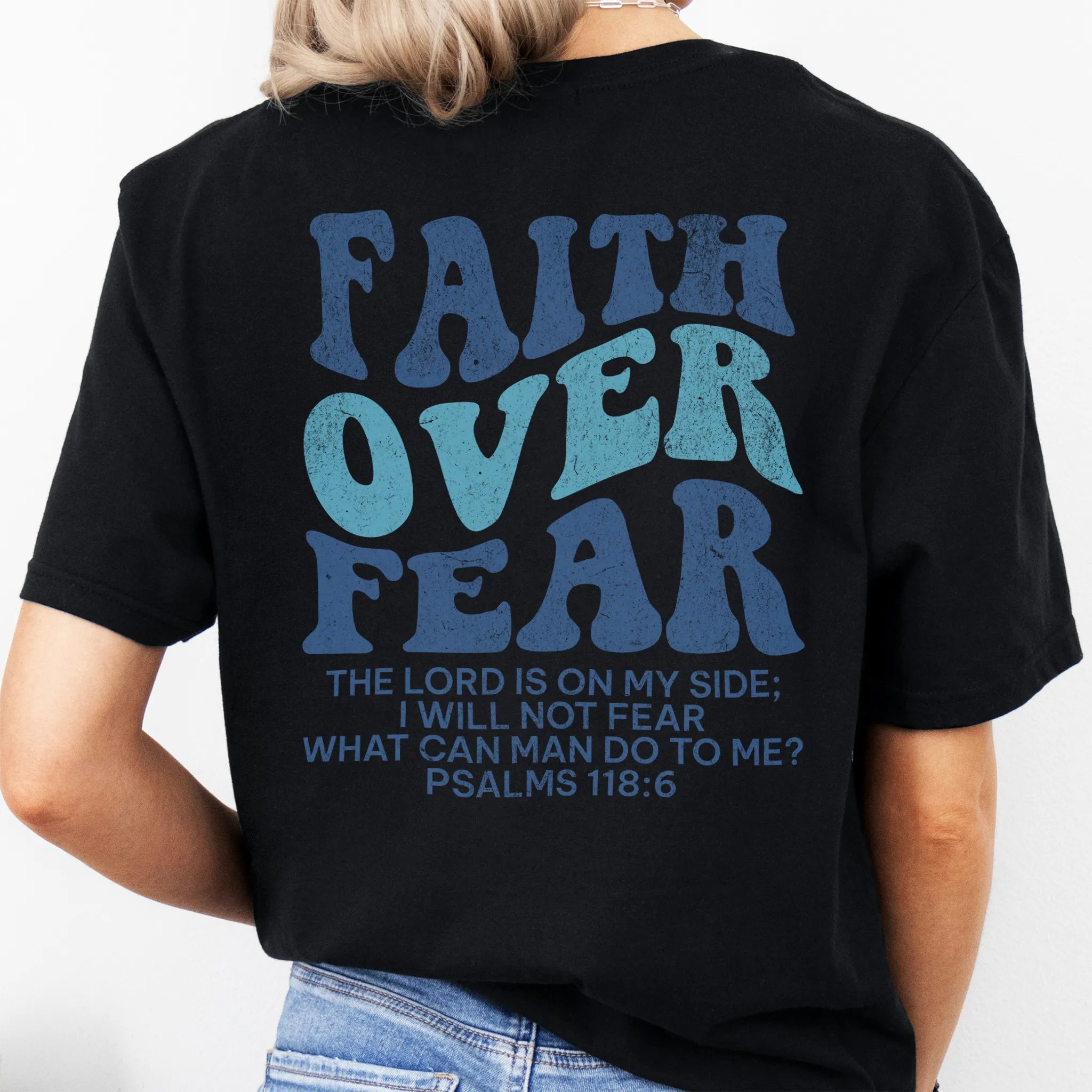 Black Oakley June t shirt, large back lettering reads Faith Over Fear with supporting scripture lines, studio back view