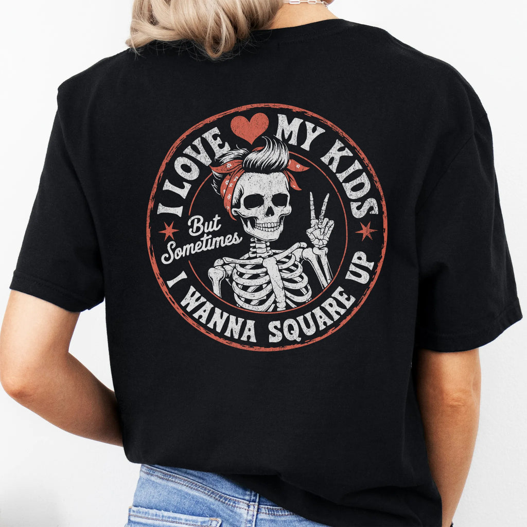 Black t-shirt – large back graphic with skeleton mom in bandana and peace sign inside a round badge, headline reads “I Love My Kids But Sometimes I Wanna Square Up”, studio back view