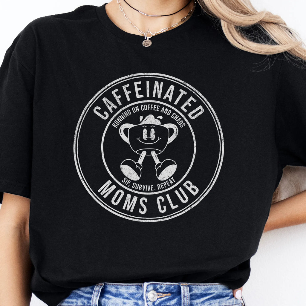 Black Oakley June T Shirt front view large Caffeinated Moms Club circle badge coffee cup mascot text Running on Coffee and Chaos Sip Survive Repeat distressed