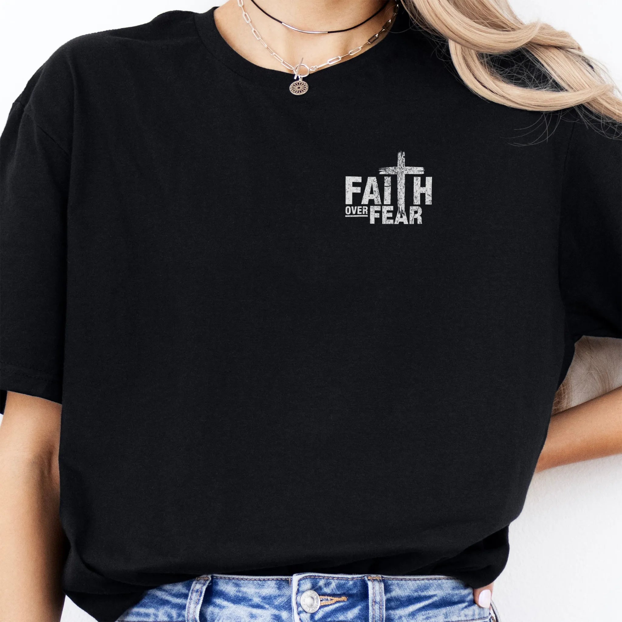 Black Oakley June t shirt, left chest badge reads Faith Over Fear with small cross, relaxed modern fit, studio front view
