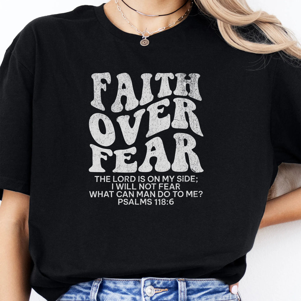 Black Oakley June t shirt, large front lettering reads Faith Over Fear with supporting lines The Lord Is On My Side I Will Not Fear What Can Man Do To Me, studio front view