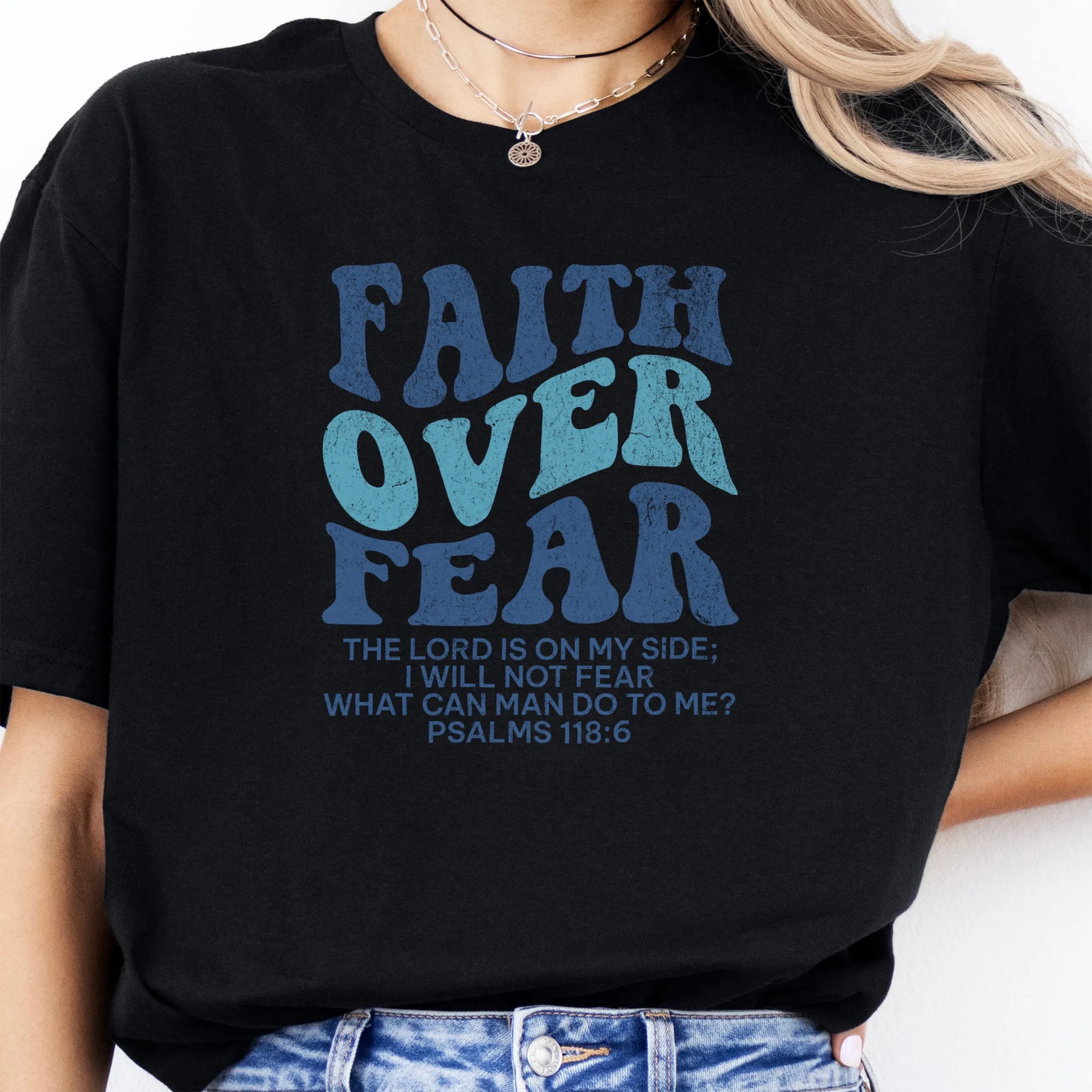 Black Oakley June t shirt, large front lettering reads Faith Over Fear with supporting lines The Lord Is On My Side I Will Not Fear What Can Man Do To Me, studio front view