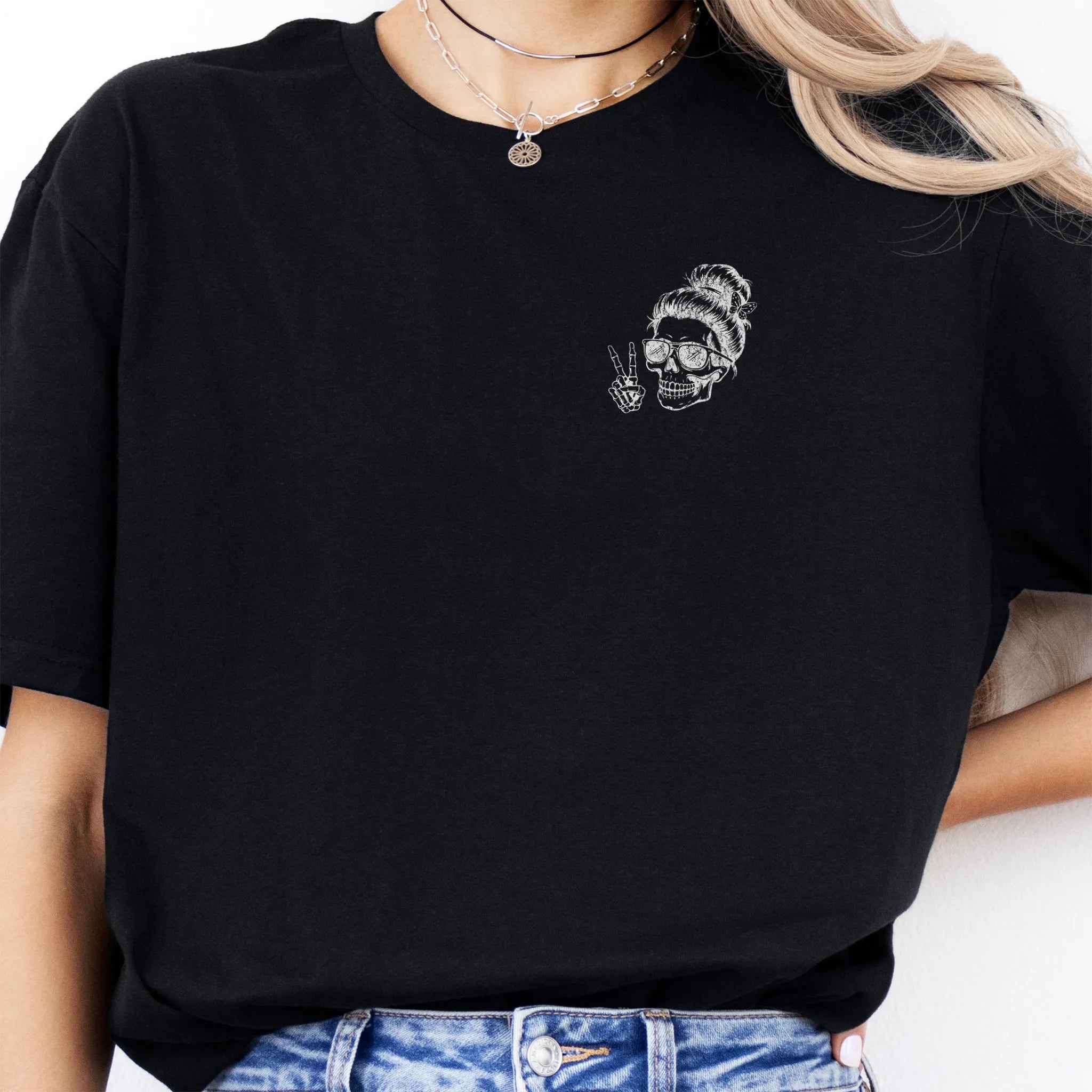 Black Oakley June T Shirt front view small left chest skull with messy bun sunglasses peace sign minimalist mark distressed print