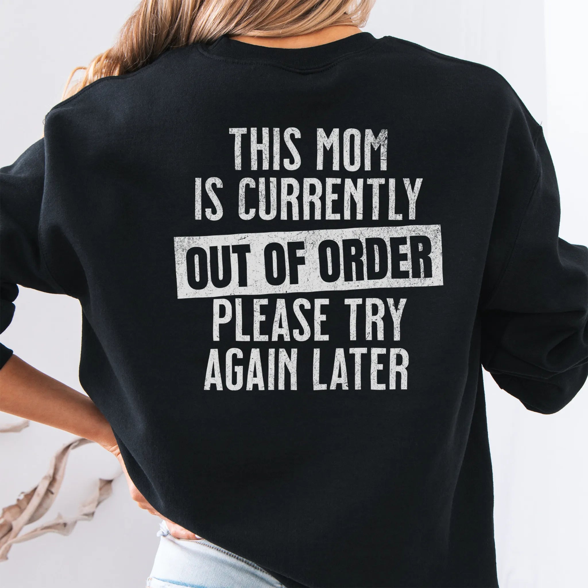 Black sweatshirt – large back text “This Mom Is Currently Out of Order, Please Try Again Later”, relaxed modern fit, studio back view