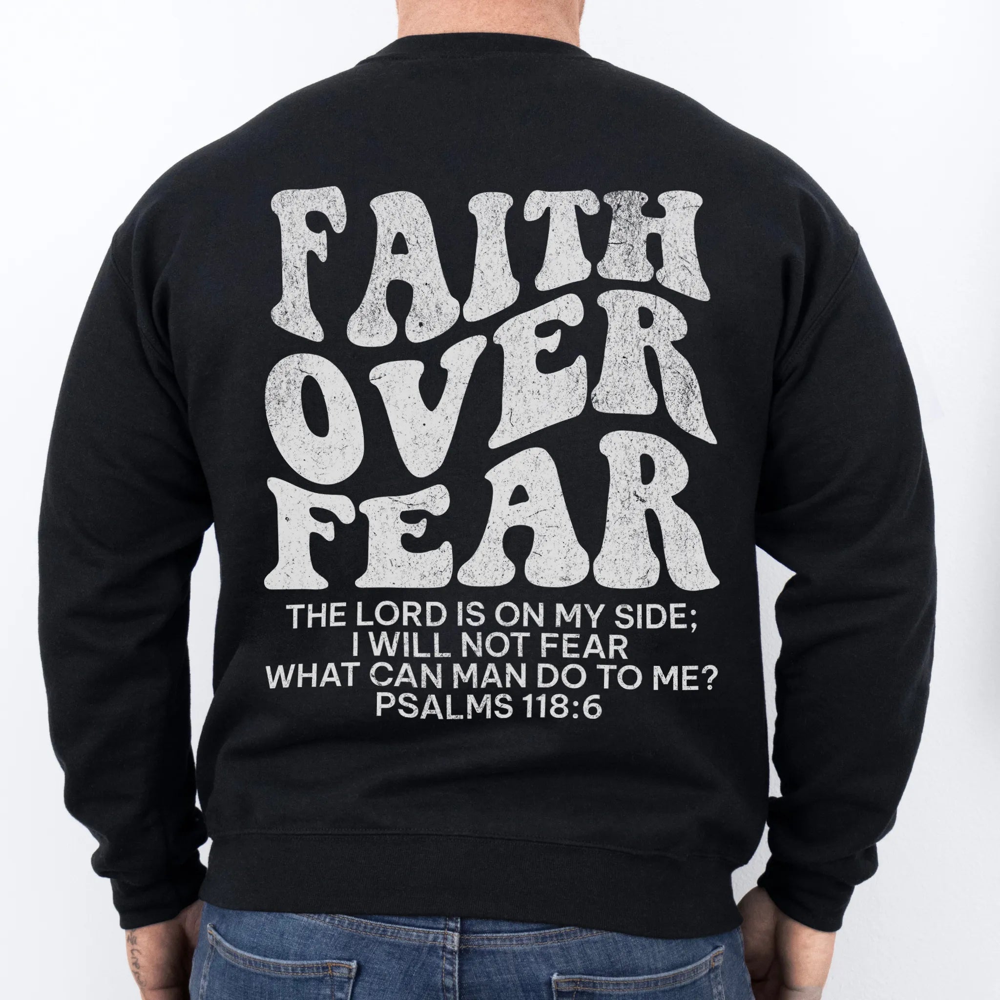 Black Oakley June sweatshirt, mens fit, large back lettering reads Faith Over Fear with supporting scripture lines, studio back view
