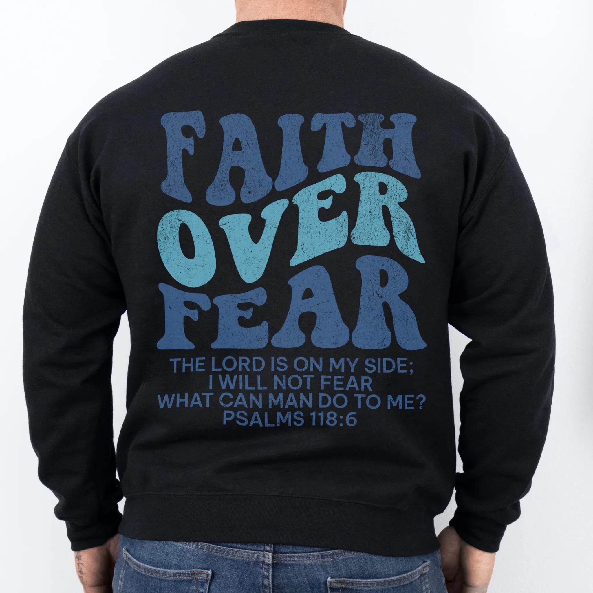 Black Oakley June sweatshirt, mens fit, large back lettering reads Faith Over Fear with supporting scripture lines, studio back view