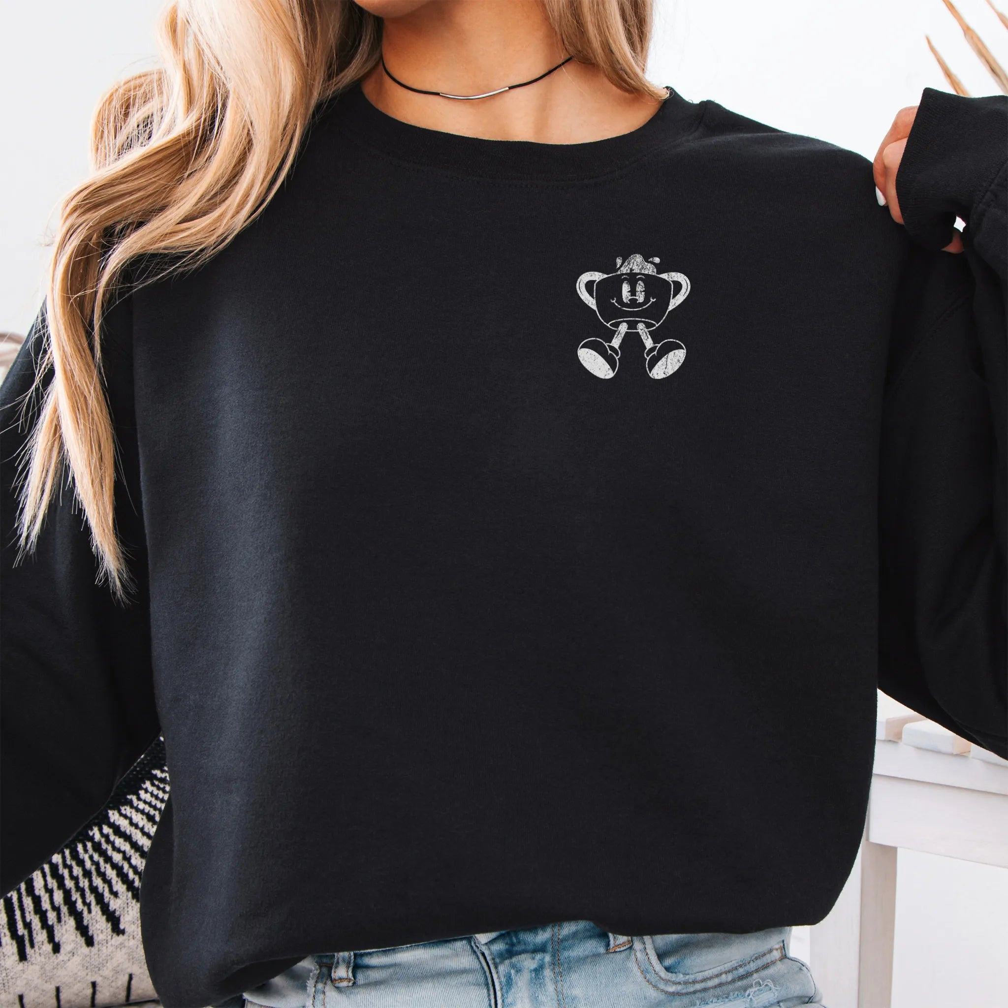 Black Oakley June Sweatshirt back view Caffeinated Moms Club large circle badge text Running on Coffee and Chaos Sip Survive Repeat vintage coffee cup mascot distressed