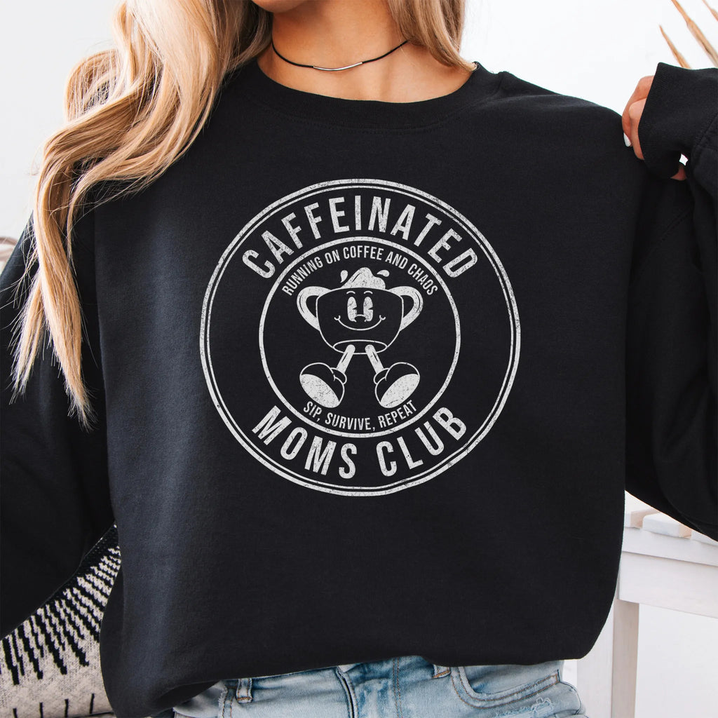 Black Oakley June Sweatshirt front view large Caffeinated Moms Club circle badge coffee cup mascot text Running on Coffee and Chaos Sip Survive Repeat mono black ink distressed