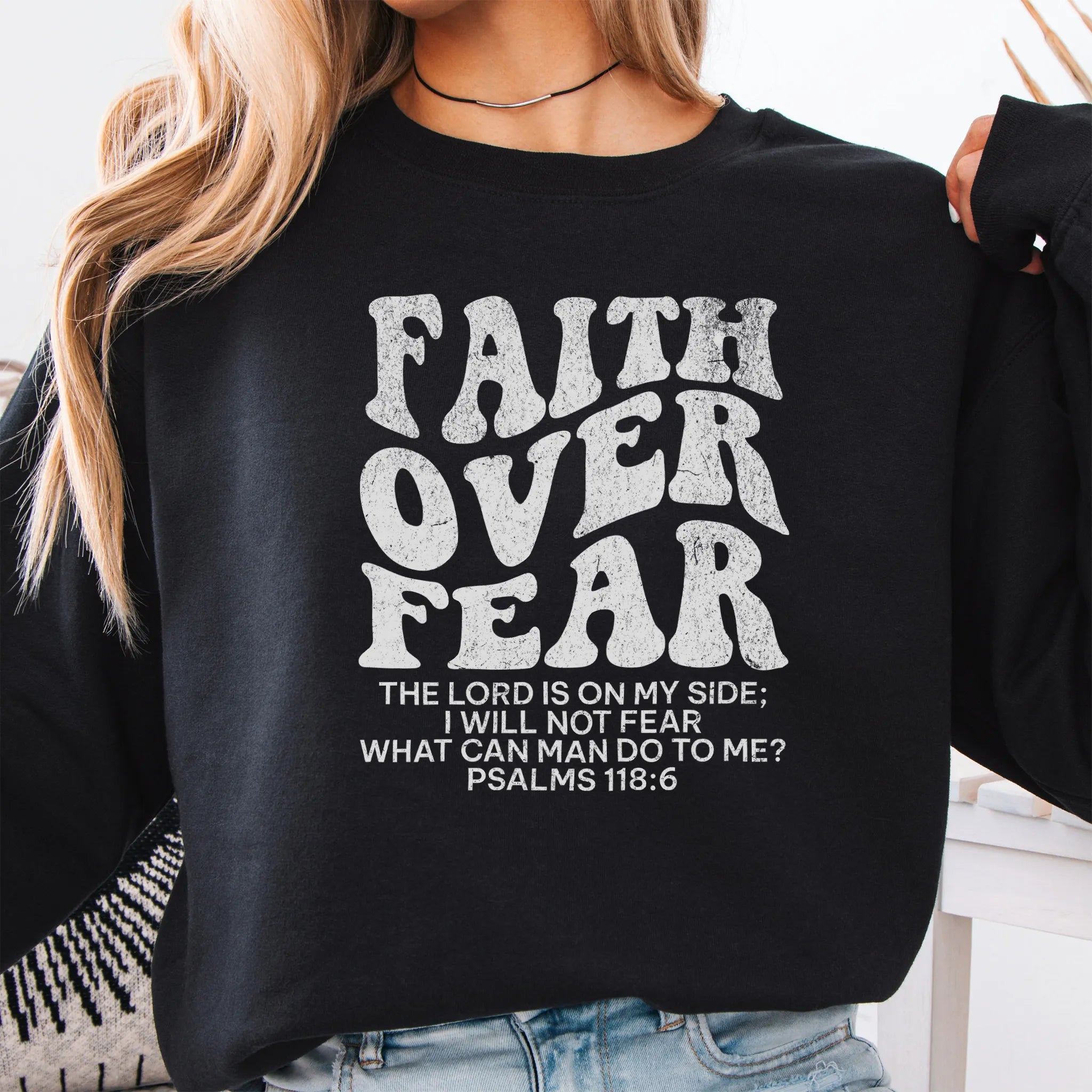 Black Oakley June sweatshirt, large front lettering reads Faith Over Fear with supporting lines The Lord Is On My Side I Will Not Fear What Can Man Do To Me, studio front view
