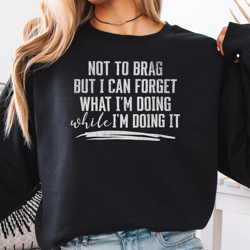 Black Oakley June Sweatshirt front view large text Not To Brag But I Can Forget What I’m Doing While I’m Doing It underline distressed print