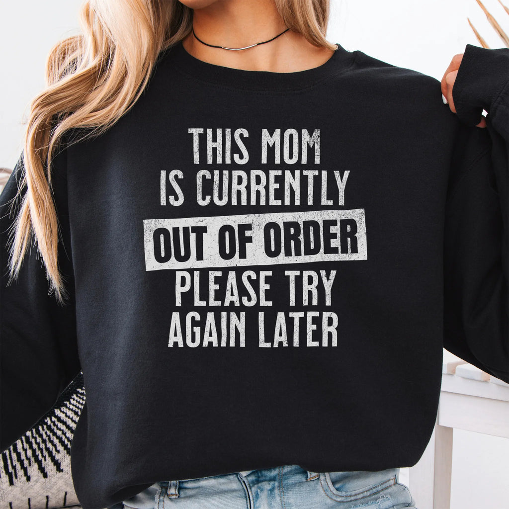Black sweatshirt – large front text reads “This Mom Is Currently Out of Order, Please Try Again Later”, relaxed modern fit, cropped to torso, studio front view