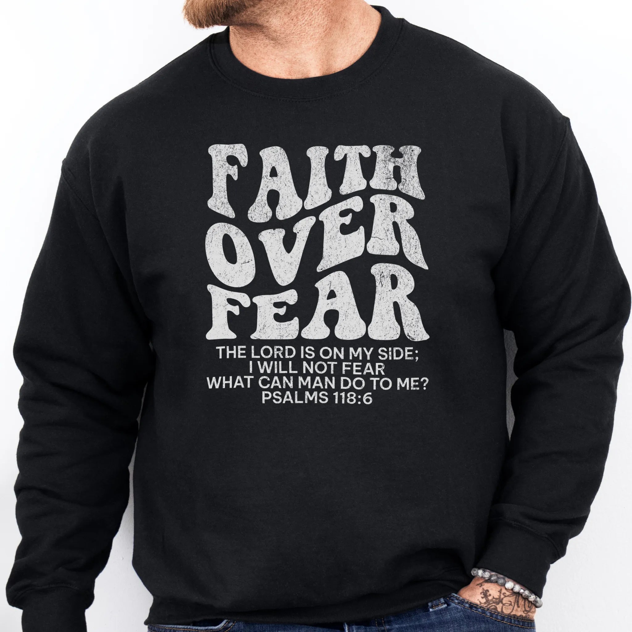 Black Oakley June sweatshirt, mens fit, left chest badge reads Faith Over Fear with cross, studio front view