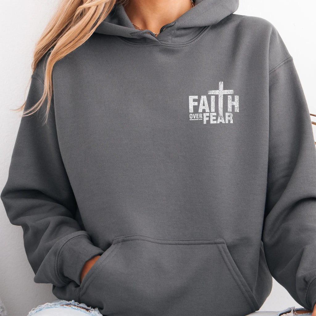 Charcoal Oakley June hoodie, left chest badge reads Faith Over Fear with small cross, kangaroo pocket and relaxed modern fit, studio front view