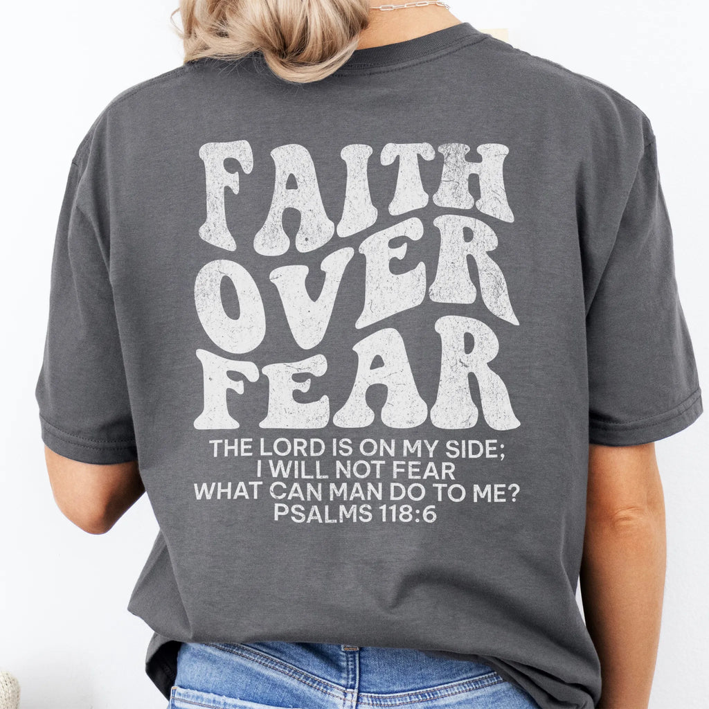 Charcoal Oakley June t shirt, large back lettering reads Faith Over Fear with supporting scripture reference Psalms one eighteen six, studio back view