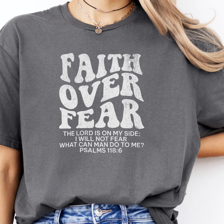 Charcoal Oakley June t shirt, large front lettering reads Faith Over Fear with supporting lines The Lord Is On My Side I Will Not Fear What Can Man Do To Me, studio front view