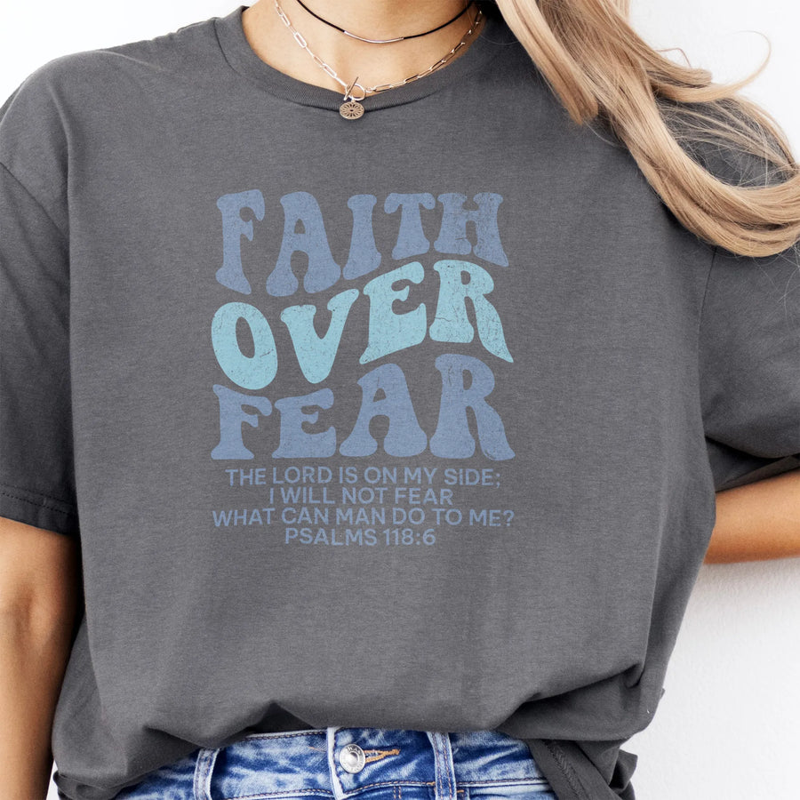 Charcoal Oakley June t shirt, large front lettering reads Faith Over Fear with supporting lines The Lord Is On My Side I Will Not Fear What Can Man Do To Me, studio front view