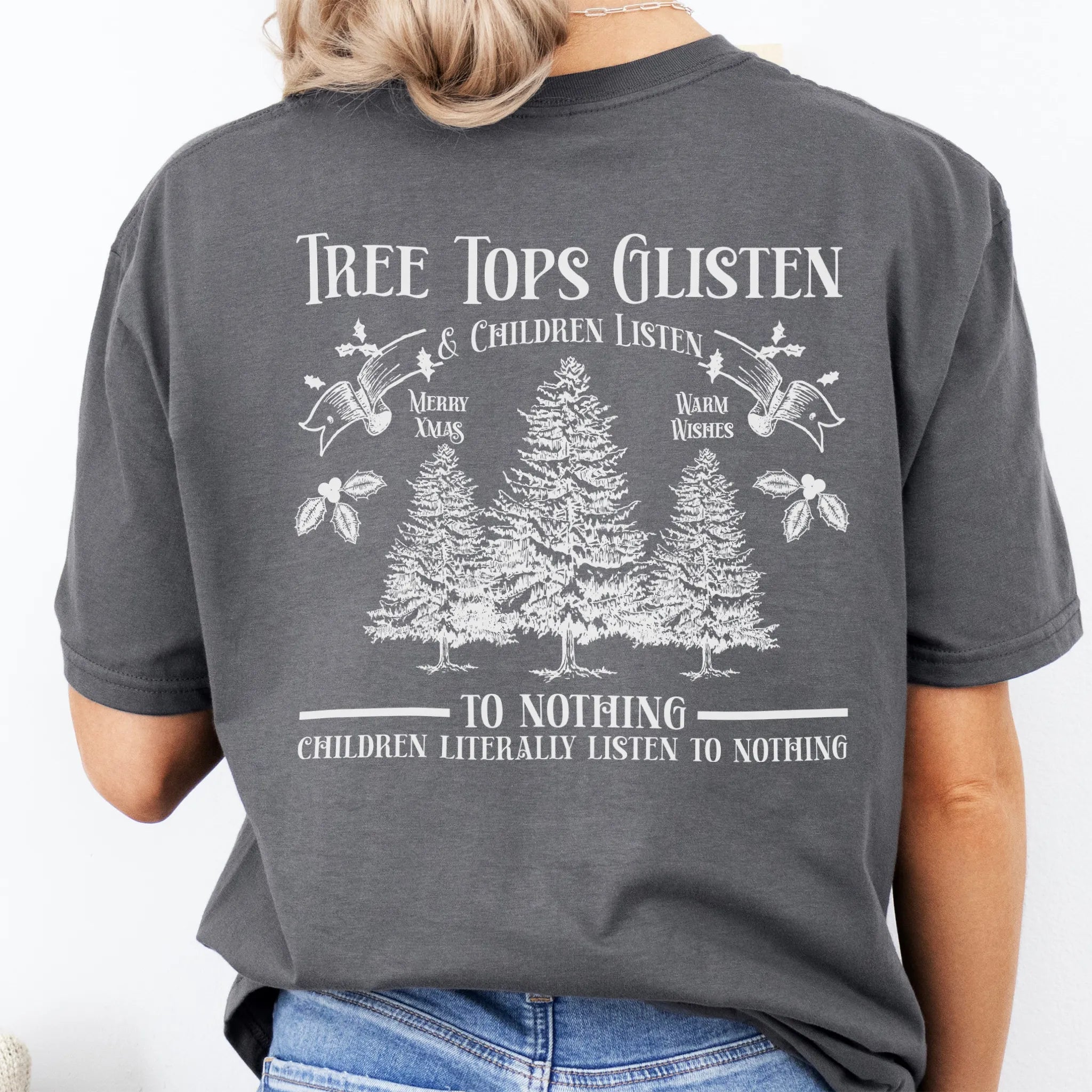 Charcoal Oakley June tee large back print Tree Tops Glisten and Children Listen to Nothing with three evergreen trees, doves, and holly
