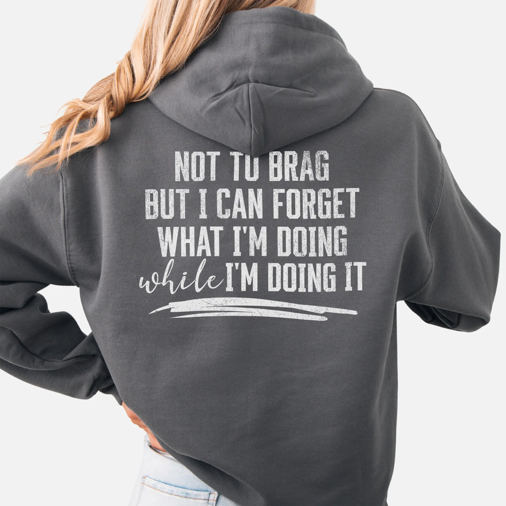 Charcoal Oakley June Hoodie back view large text Not To Brag But I Can Forget What I’m Doing While I’m Doing It underline distressed print