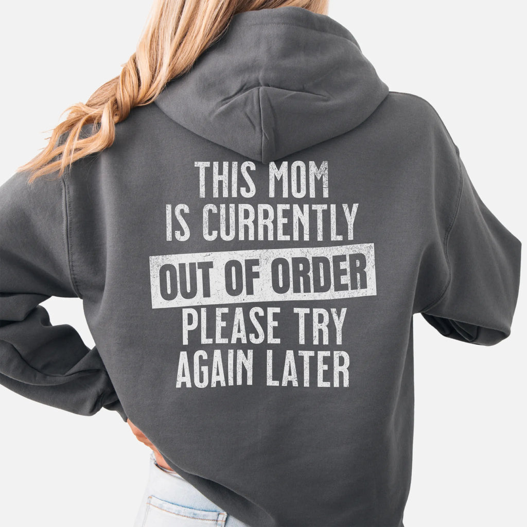 Charcoal hoodie – large back text reads “This Mom Is Currently Out of Order, Please Try Again Later”, relaxed modern fit with hood up, studio back view