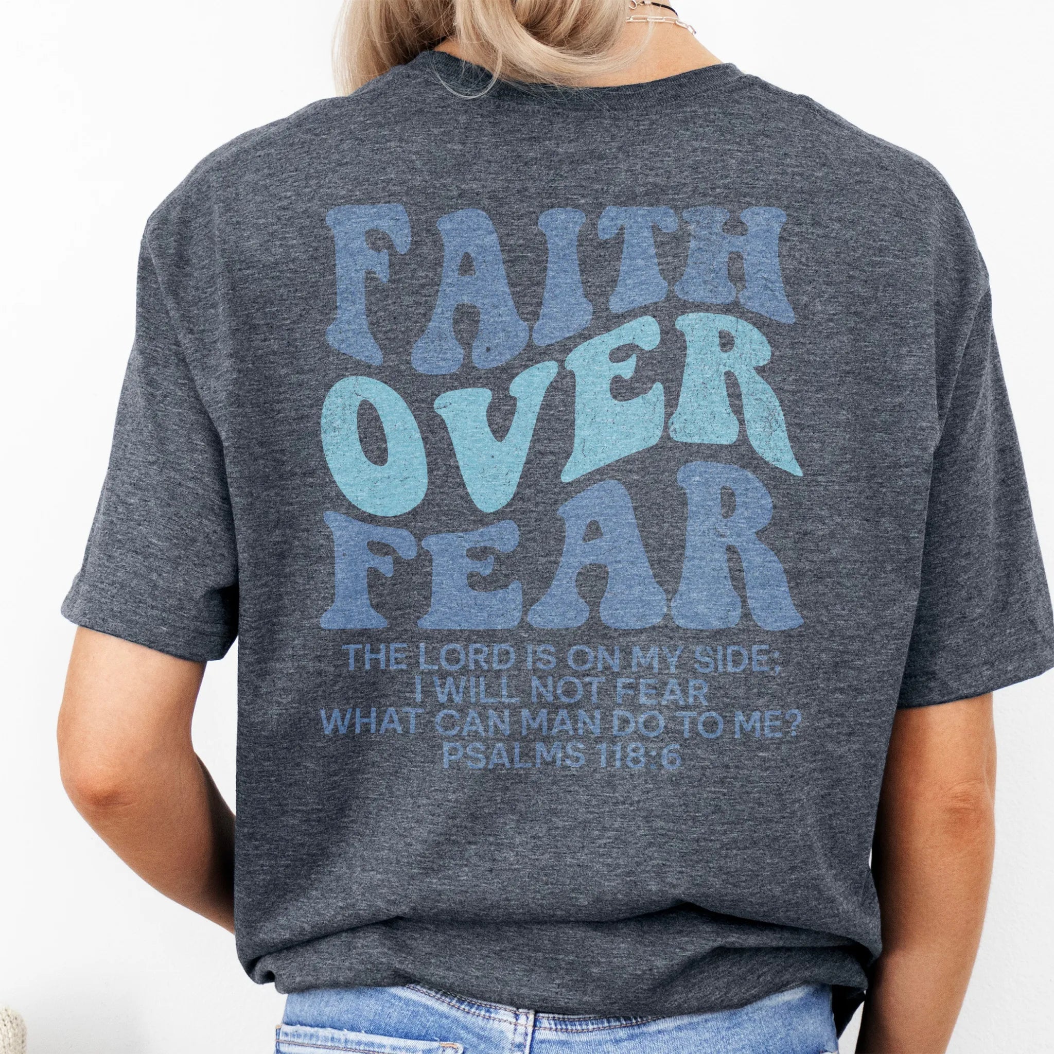 Dark Heather Oakley June t shirt, large back lettering reads Faith Over Fear with supporting scripture lines, studio back view