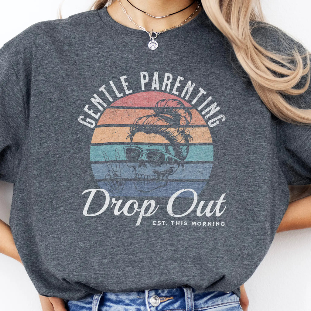 Dark Heather Oakley June T Shirt front view Gentle Parenting Drop Out large chest graphic skull with messy bun sunglasses peace sign round retro stripe badge text Est This Morning distressed print