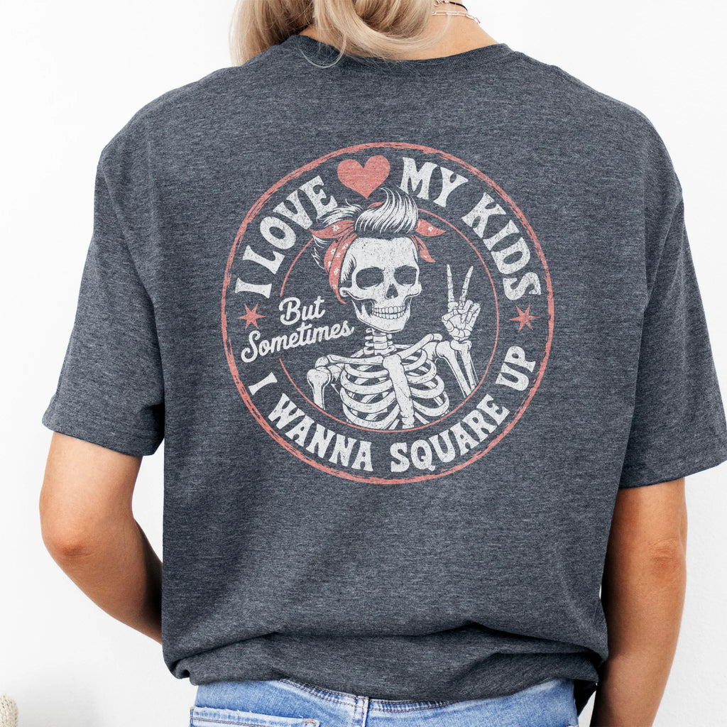 Dark Heathert-shirt – large back graphic with skeleton mom in bandana and peace sign inside a round badge, headline reads “I Love My Kids But Sometimes I Wanna Square Up”, studio back view