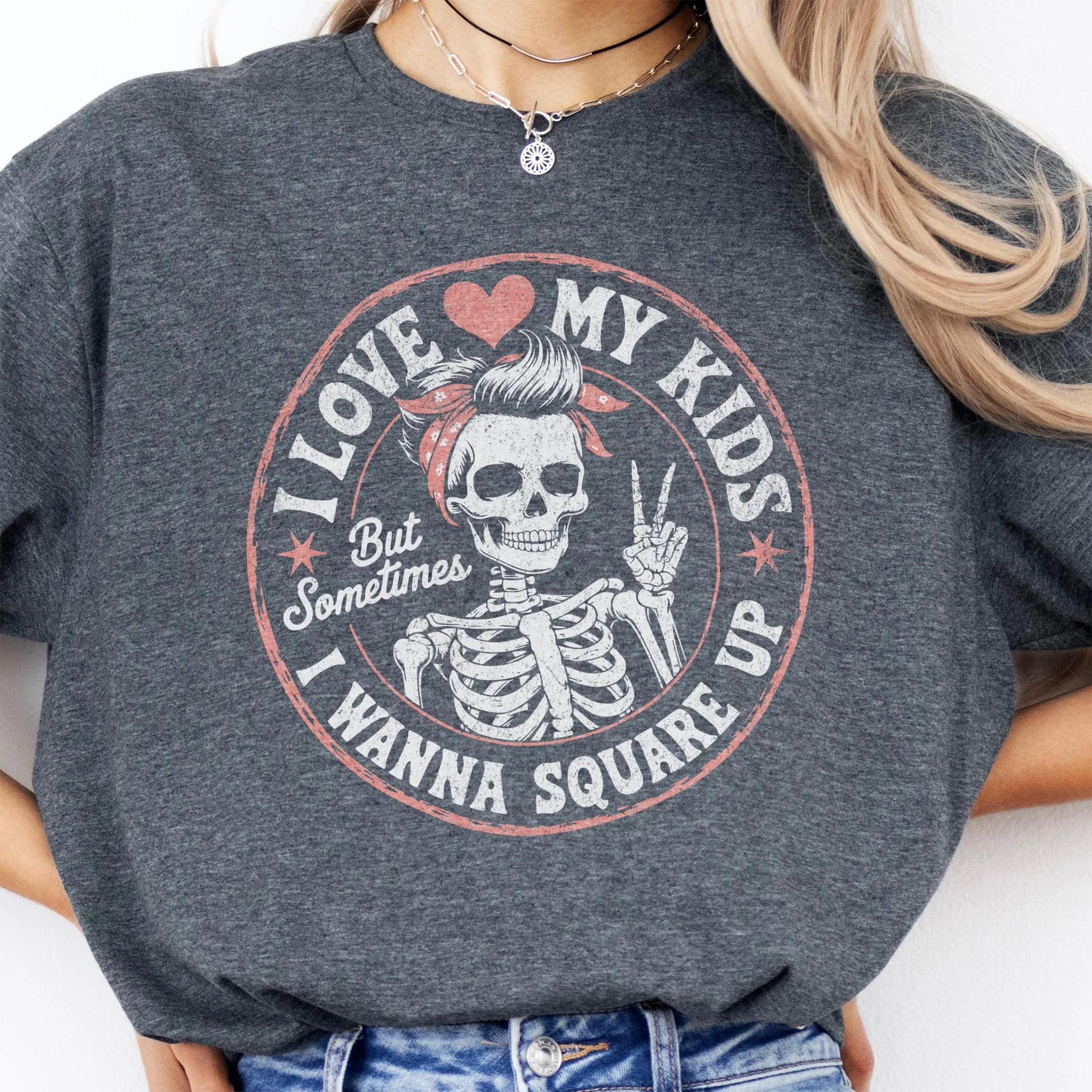 Dark Heather t-shirt – large front circle graphic with skeleton mom in bandana and peace sign, headline reads “I Love My Kids But Sometimes I Wanna Square Up”, studio front view
