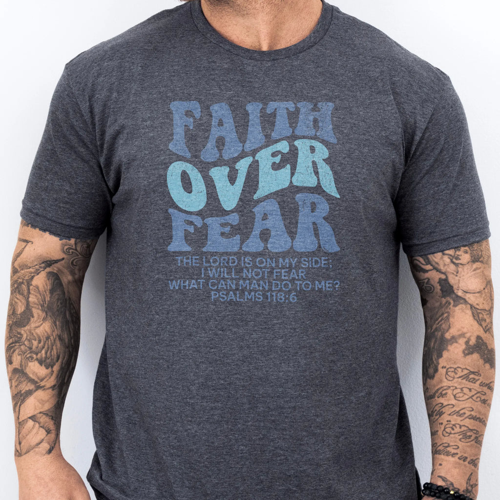 Dark Heather Oakley June t shirt, mens fit, large front lettering reads Faith Over Fear with supporting lines The Lord Is On My Side I Will Not Fear What Can Man Do To Me, studio front view