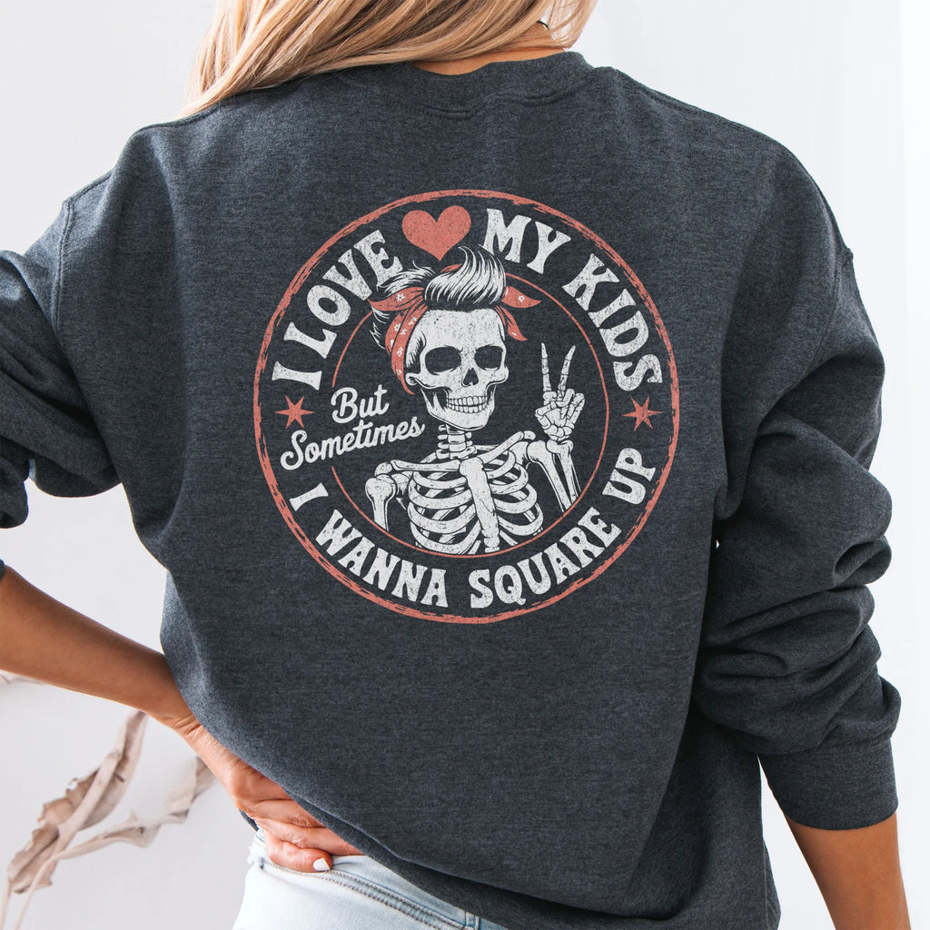 Dark Heather sweatshirt – large back circle graphic with skeleton mom giving a peace sign, headline reads “I Love My Kids But Sometimes I Wanna Square Up”, studio back view