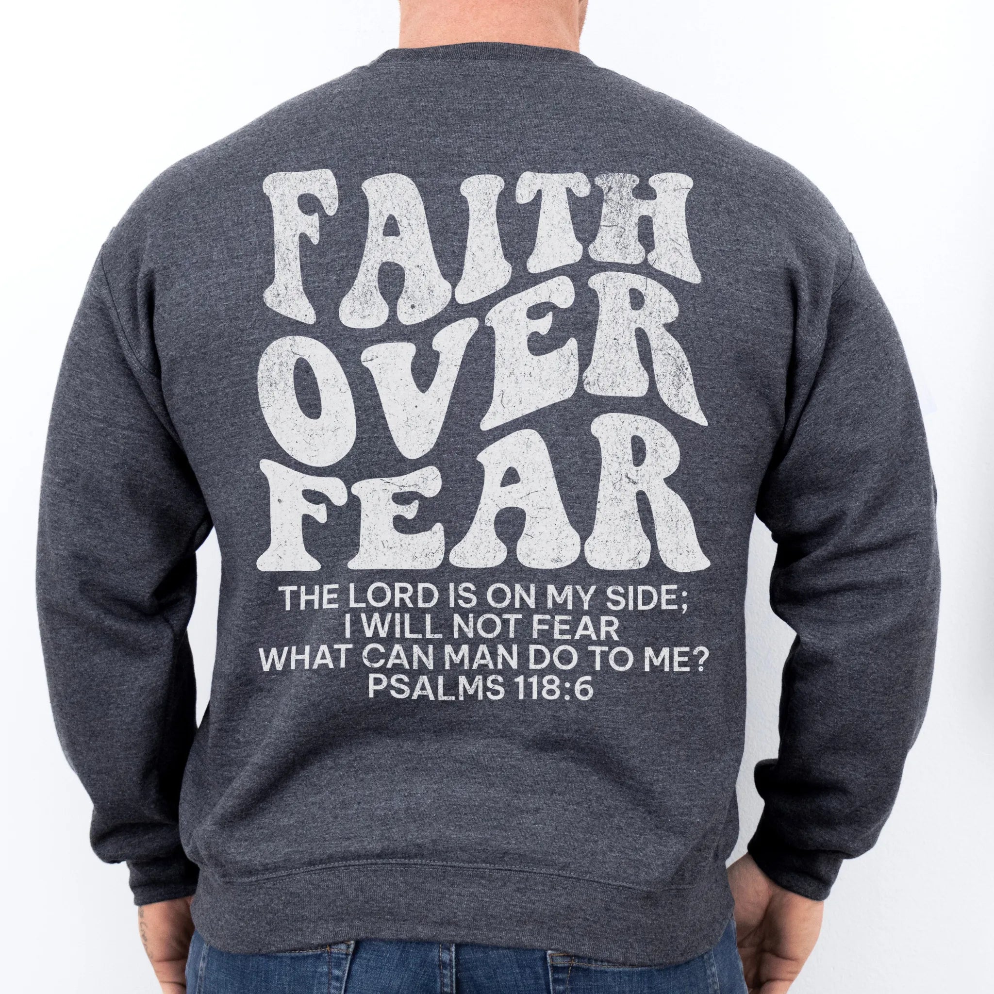 Dark Heather Oakley June sweatshirt, mens fit, large back lettering reads Faith Over Fear with supporting scripture lines, studio back view