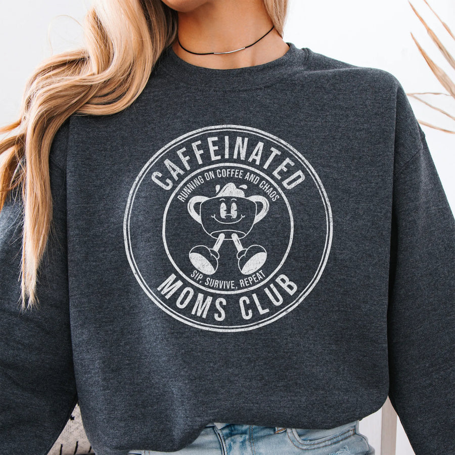 Dark Heather Oakley June Sweatshirt front view large Caffeinated Moms Club circle badge coffee cup mascot text Running on Coffee and Chaos Sip Survive Repeat mono black ink distressed
