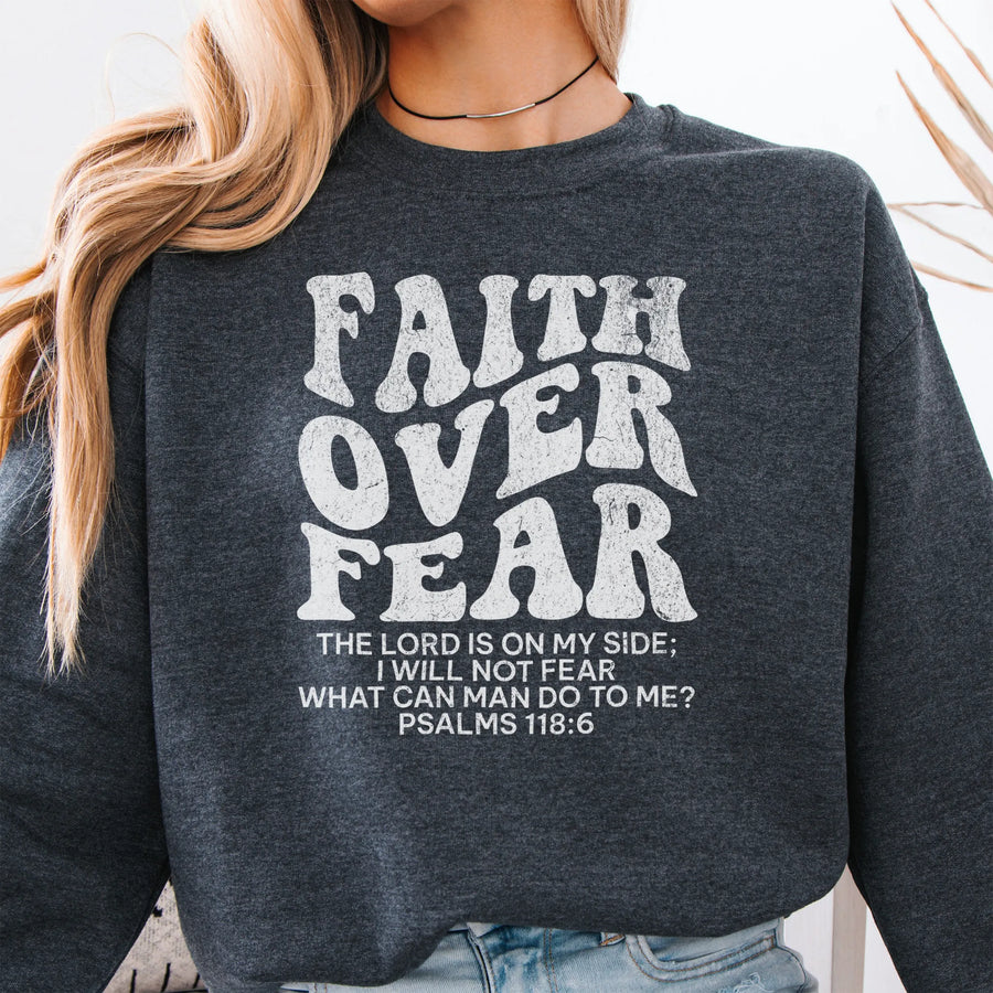 Dark Heather Oakley June sweatshirt, large front lettering reads Faith Over Fear with supporting lines The Lord Is On My Side I Will Not Fear What Can Man Do To Me, studio front view