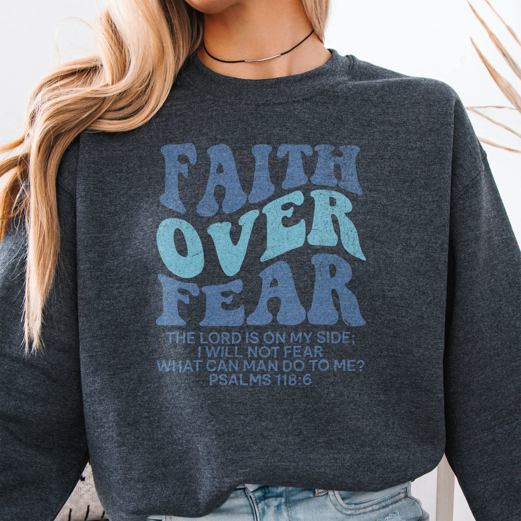 Dark Heather Oakley June sweatshirt, large front lettering reads Faith Over Fear with supporting lines The Lord Is On My Side I Will Not Fear What Can Man Do To Me, studio front view