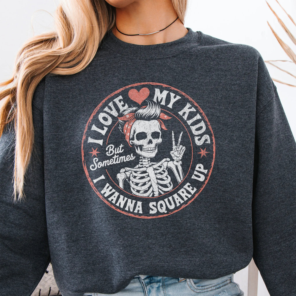 Dark Heather sweatshirt – large front circle graphic with skeleton mom giving a peace sign, headline reads “I Love My Kids But Sometimes I Wanna Square Up”, studio front view